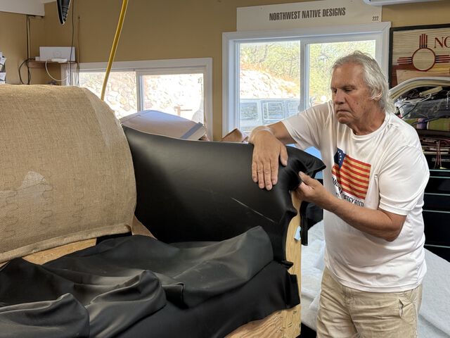 Artist Ernie Apodaca working on a handcrafted sofa