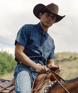 Man on horse wearing a Pendleton shirt
