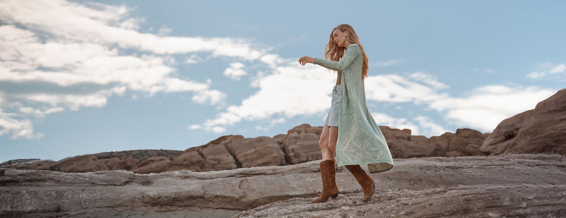 Woman walking outside wearing a Pendleton sweater