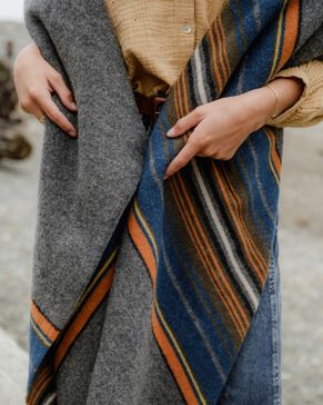 Woman outside wrapped in an Olympic National Park Blanket