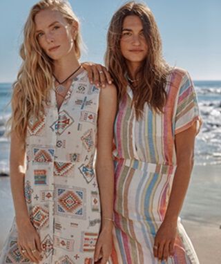 Two women on the beach wearing Pendleton Linen dresses