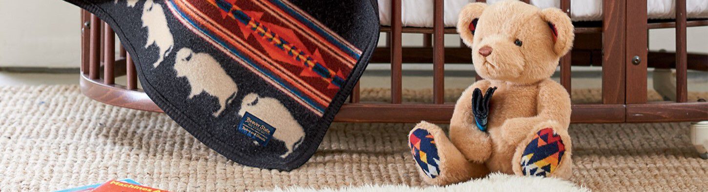 Big Medicine Crib Blanket draped over crib 