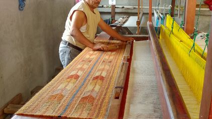 Man weaving the Clay Canyon Rug